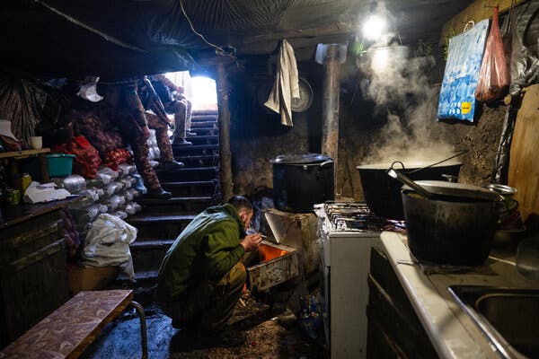 Ukrainian soldiers with the Border Guard cooking in a kitchen dug into the ground behind the front lines in eastern Ukraine last month.