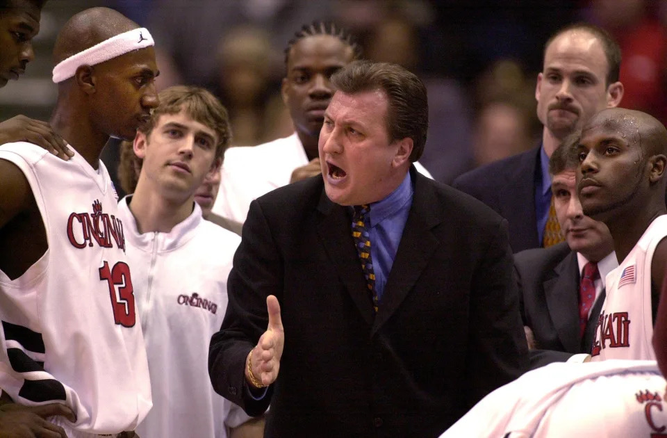 University of Cincinnati Basketball coach Bob Huggins, center, talks with his players during a first half timeout in their game against Marquette Friday night February 22, 2002 at the Shoemaker Center in Cincinnati.