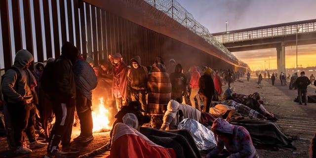 Illegal immigrants gather next to the U.S.-Mexico border fence in El Paso, Texas, on Dec. 22, 2022. 