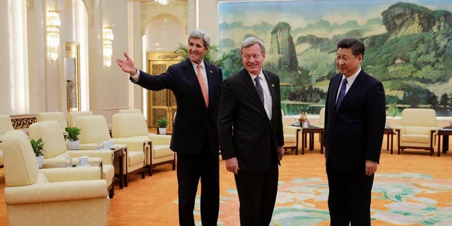 US Ambassador to China Max Baucus (C) looks on as US Secretary of State John Kerry (L) introduces his delegation to Chinese President Xi Jinping (R) at the Great Hall of the People in Beijing on January 27, 2016.