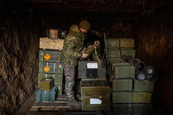 Ukrainian soldiers with the Border Guard grabbing ammunition from a bunker in eastern Ukraine last month.